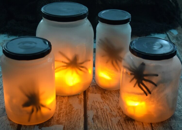 food jars with rubber spiders